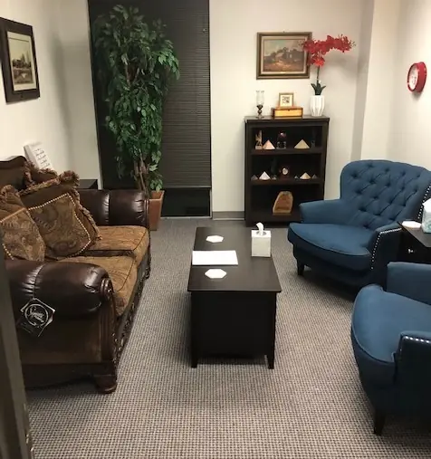 The counseling room at 1100 Nasa Parkway: sofa, chairs, and a coffee table